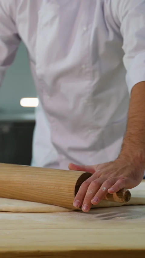 Chef Rolling Flat Dough on Counter Stock Footage 299664833