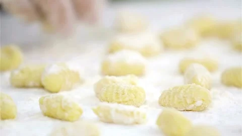 Chef rolling fresh handmade potato gnocchi on floured table Video stock 333828893