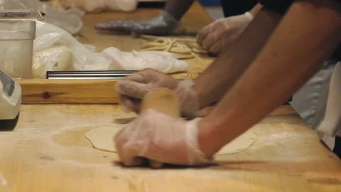The chef is rolling out the dough in the restaurant kitchen. Stock Footage 131131041