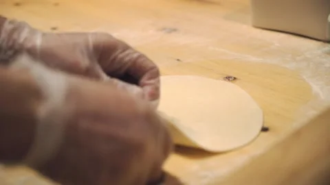The chef is rolling out the dough in the restaurant kitchen. Stock Footage 131131054