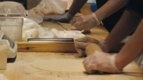 The chef is rolling out the dough in the restaurant kitchen. Stock Footage 132310365
