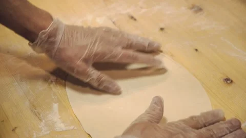 The chef is rolling out the dough in the restaurant kitchen. Stock Footage 132310404