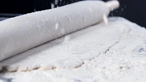 The chef is rolling out the dough with a rolling pin. Stock Footage 140182479