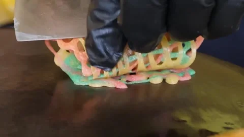 Chef Rolling Rainbow Lace Crepe Around Sausage on Grill Stock Footage 345692608
