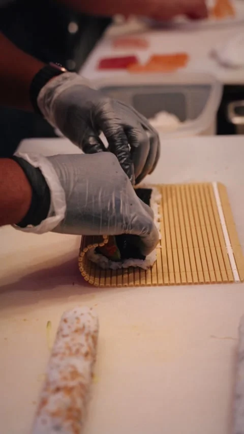 Chef rolling sushi roll dynamic vertical 4K video Stock Footage 317408582