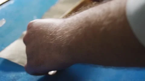 Chef rolling up white cod fish for baking in a Parchment Pape renvelope Stock Footage 203579300