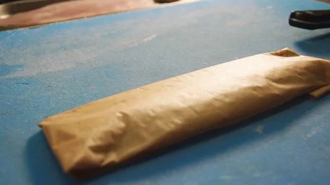 Chef rolling up white cod fish for baking in a Parchment Pape renvelope Stock Footage 205152661