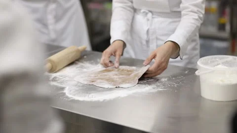 The chef rolls the dough on the countertop. Stock Footage 121035934