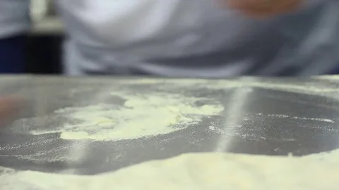 Chef rolls out the dough for pizza Stock-Footage 73425697