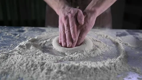 Chef rolls out dough on pizza table Stock-Footage 134954920