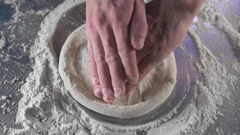 Chef rolls out dough on pizza table Stock-Footage 134954952