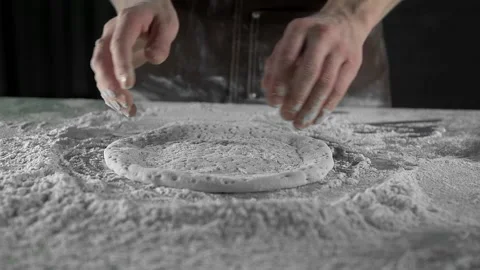 Chef rolls out dough on pizza table Stock Footage 134955005