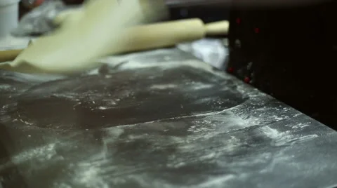 The chef rolls out the dough with a rolling pin Stock Footage 59700126