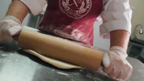 Chef in rolls out dough with rolling pin Stock Footage 155203077