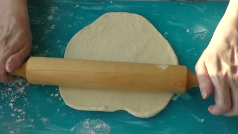 The chef rolls out the dough with a rolling pin Stock Footage 197931281