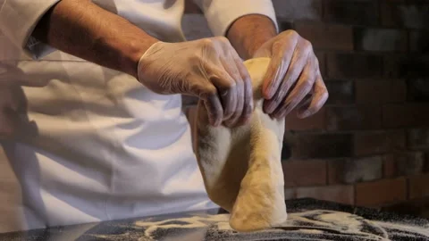 Chef rolls out the pizza dough with his own hands. Stock Footage 130974573