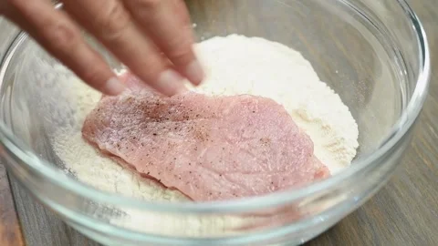 The chef rolls the slice pork loin in flour. Stock Footage 200810826