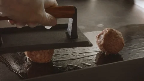 Chef of the round minced forms burger patties in hot Grilled. Slow motion video Stock Footage 113866099