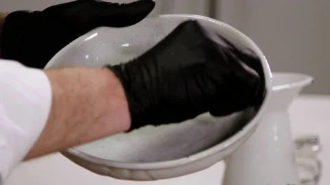 Chef rubbing a baking dish with butter. 4K Stock Footage 136490054