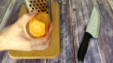 The chef rubs the carrot Stock Footage 230015276