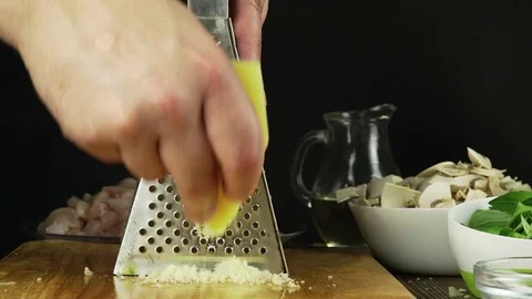 A chef rubs parmesan cheese Stock Footage 74364948