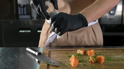 Chef salt and peppered fish Stock Footage 97880923