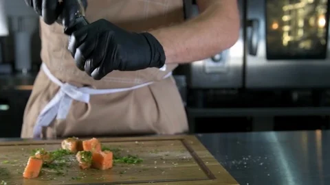 Chef salt and peppered fish Stock Footage 97880925