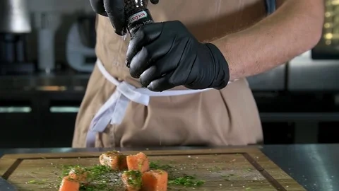 Chef salt and peppered fish Stock Footage 97880940