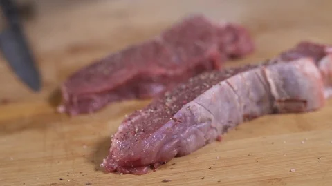 The chef salted and peppered the beef before cooking Stock Footage 128544599