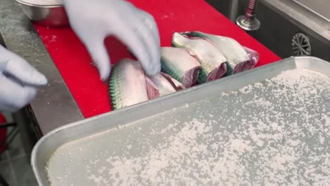 Chef Salting Fresh Fish Fillets on Metal Tray in Commercial Kitchen 库存影片 333500086