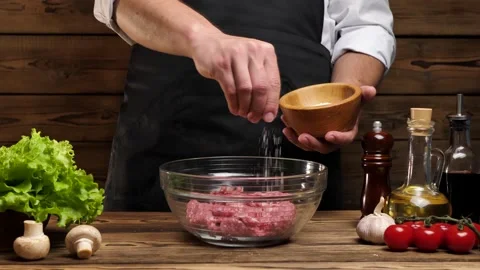 Chef salting freshly cooked ground beef Stock Footage 196841445