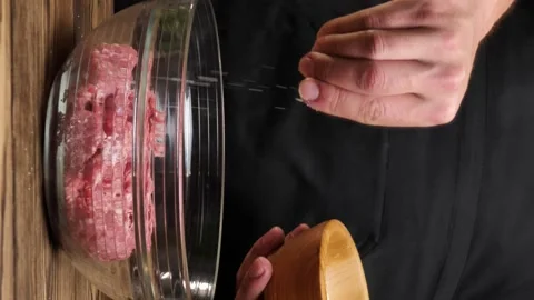 Chef salting freshly cooked ground beef.vertical screen Stock Footage 234303012