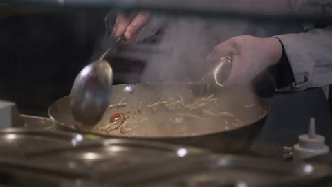 Chef Salts And Tossing Fried Vegetables With Meat In a Frying Pan, Commercial Stock Footage 72116183