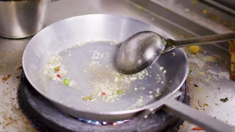 Chef SautÃ©ing Minced Garlic and Chili in Hot Oil in Frying Pan Stock-Footage 346664581