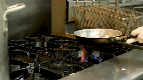 Chef saute vegetables on professional kitchen stove Stock-Footage 94247048