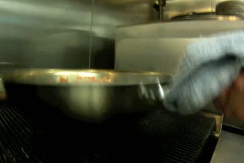 Chef Sauteeing Vegetables in Large Pan Stock Footage 11164564