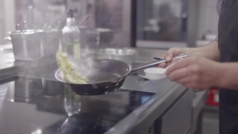 Chef Sauteing Vegetables in Pan With Steam, Restaurant Kitchen, Medium Shot Stock Footage 341421594