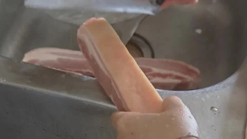 Chef Scraping Raw Pork Belly Skin with Knife in Kitchen Sink Video stock 337616803