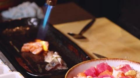 Chef Searing Fresh Salmon with a Kitchen Blowtorch in a Restaurant Stock Footage 327260879