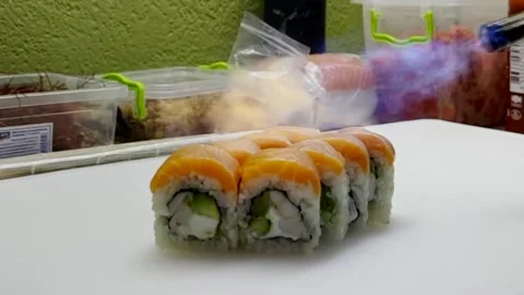 Chef sears delicious sushi on white table Stock Footage 285252411