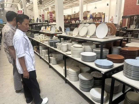 Chef selecting chinaware at the store Stock Photos