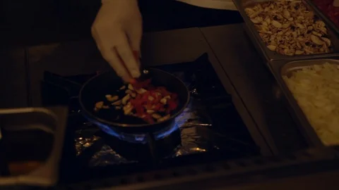 Chef selecting fresh ingredients into a pan Video stock 108112002