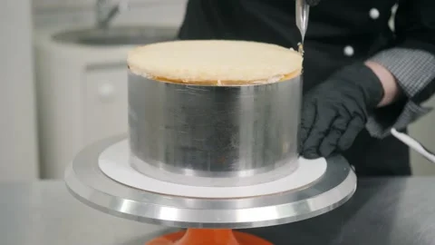 Chef separates cake from baking dish using knife on stand Stock Footage 137932185