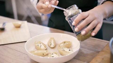 Chef serves a beautiful dish on a plate of Italian ravioli Stock Footage 125922039