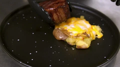 Chef serves beef steak. Slow motion. Stock Footage 303745072