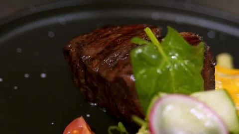 Chef serves beef steak. Slow motion. Video stock 303745131