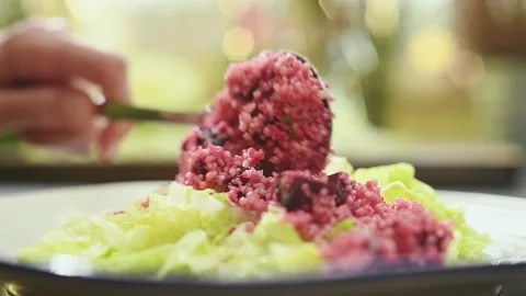 Chef serves couscous salad with beetroot  on a plate. Stock Footage 151689374