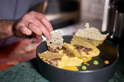 The chef serves the dish Pumpkin Risotto with with duck and parmesan cheese Stock Photos