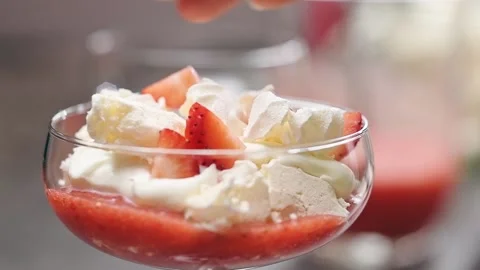 Chef serves Eton Mess dessert. Adding a slice of strawberry. Video stock 152529253