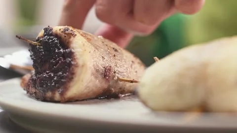 Chef serves fish roulade with olives on a plate. Stock-Footage 157539897